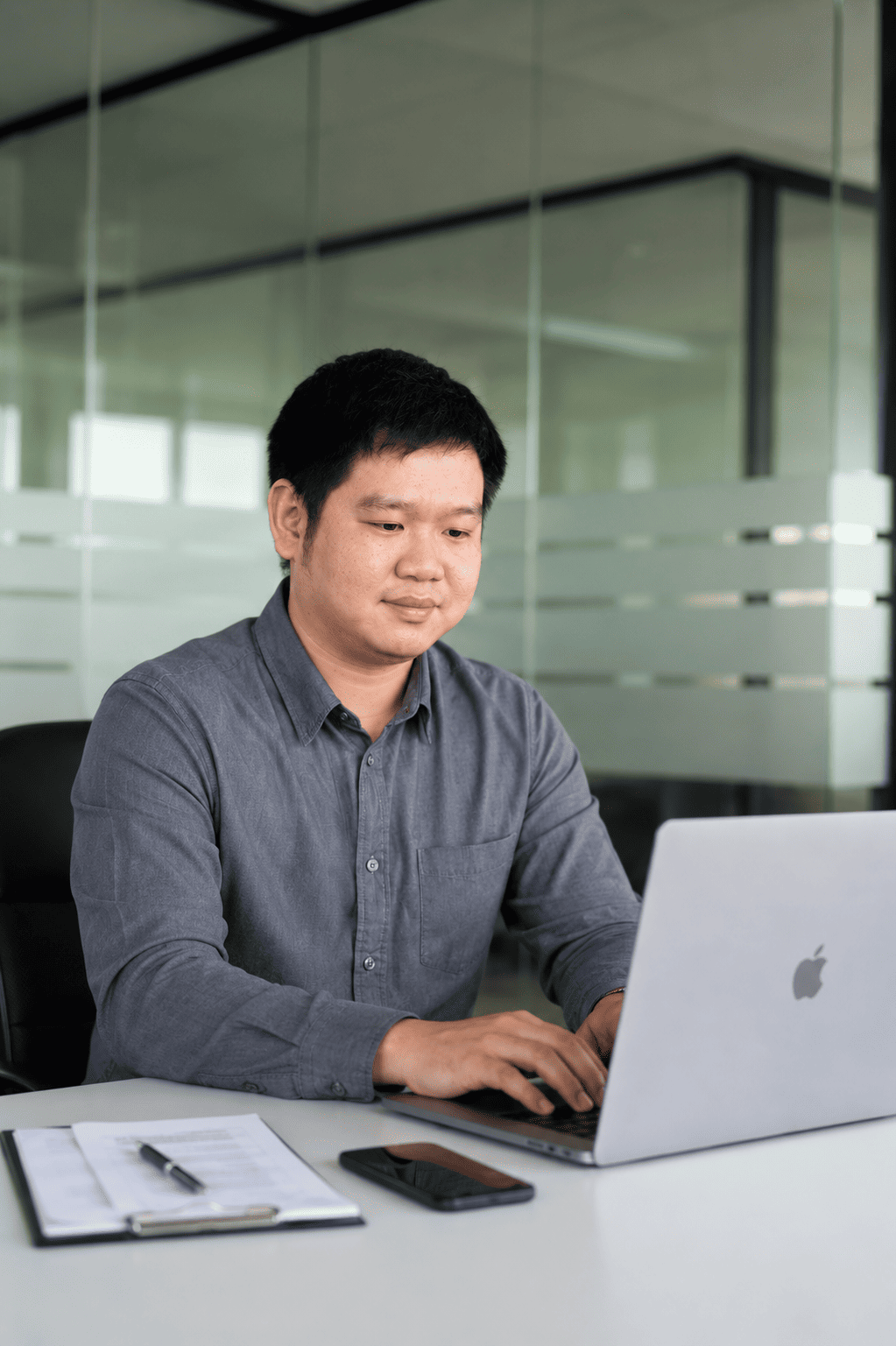Raymond Chew working at a laptop